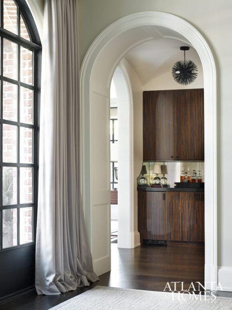 Rich ebony cabinetry creates the perfect backrop for a scotch bar. below At one end of the formal living room, a Steven Seinberg painting serves as the backdrop for the nearby piano. Seinberg is represented by Pryor Fine Art.