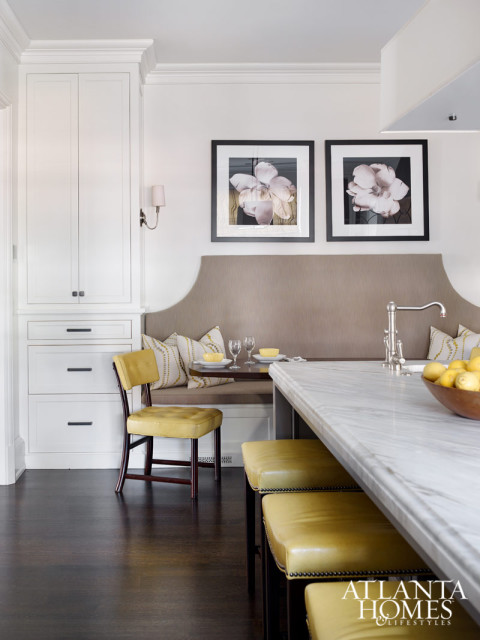 Inspired by the graceful curves accenting the cabinetry by Block & Chisel, Millner repeated the pattern throughout the kitchen. The custom banquette was a collaboration between Millner and Douglass Workroom. Hood, Smithworks Iron & Design. Stools, Hickory Chair. Backsplash and counters, Marmi Natural Stone. Light fixture, Restoration Hardware.