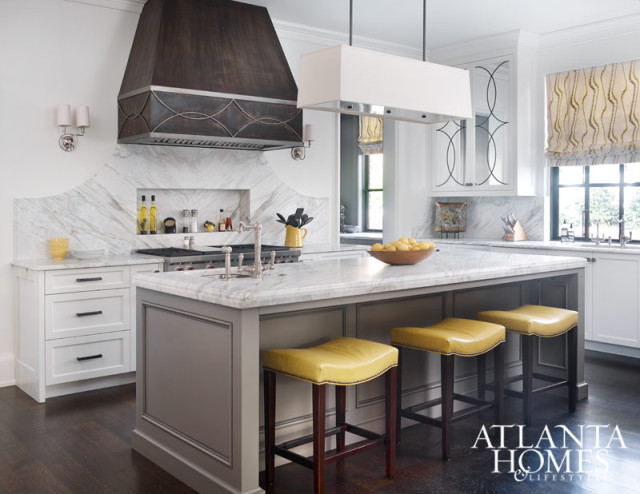 Inspired by the graceful curves accenting the cabinetry by Block & Chisel, Millner repeated the pattern throughout the kitchen. The custom banquette was a collaboration between Millner and Douglass Workroom. Hood, Smithworks Iron & Design. Stools, Hickory Chair. Backsplash and counters, Marmi Natural Stone. Light fixture, Restoration Hardware.