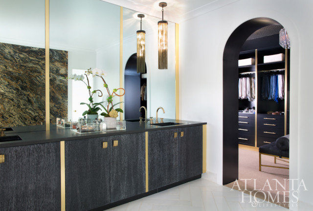 White, black and brass accents preside over the master bedroom and bath; cabinets don vintage hardware sourced by Lee.