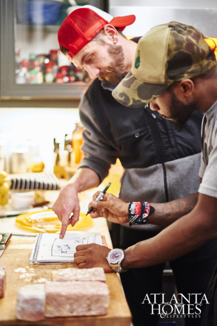 Chef Tyler Williams and Andre Brookins prepping for the five-course meal from the kitchen.