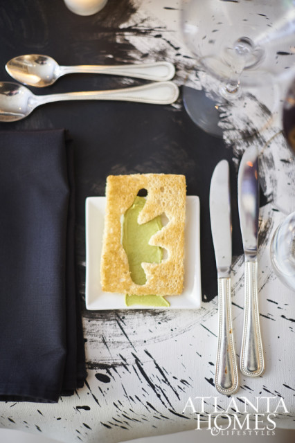 Pressed brioche and pesto add drama to hand-painted tablecloths by Mark Boomershine.
