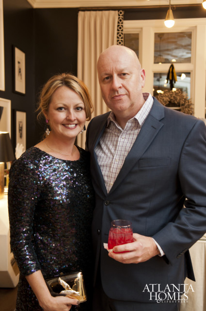 Woman in sequined top and man in suit holding a red drink, with Atlanta Homes & Lifestyles logo in the corner.