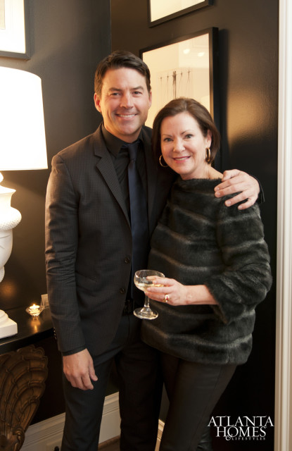 Man in a dark suit and woman in a faux fur jacket holding champagne glasses, with the Atlanta Homes & Lifestyles logo in the lower right corner.