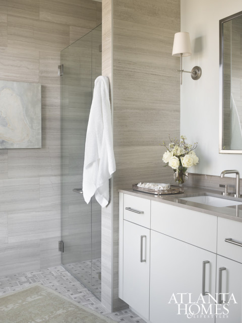 A sleek bathroom maintains the luxury hotel attitude of the Mandarin Oriental. Rug by Moattar, sconces from Circa Lighting and mirror from Restoration Hardware.