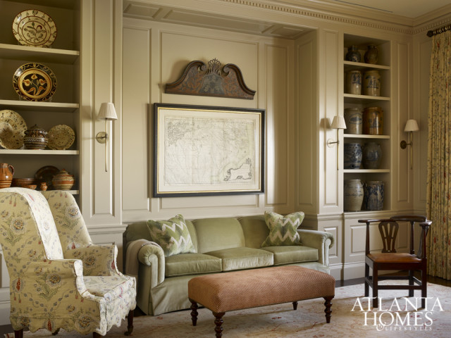 The homeowners’ sofa and ottoman were reupholstered to incorporate the soft color palette of the Oushak rug from Designer Carpets. A collection of Southern pottery and stoneware commands attention in the shelves flanking the seating area.