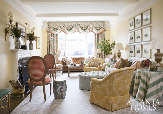 Framed prints from Fred Reed balance porcelains from Jane Marsden Antiques on the mantel. A pair of chairs from Lee Jofa upholstered in a sunny yellow chinoiserie by Scalamandré adds a bright pop to the room. Carpet by Stark and lighting by Parc Monceau.