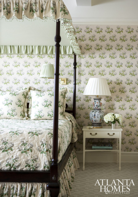 The four-poster bed from The New Traditionalists is encapsulated in the Colefax & Fowler chintz used throughout the master bedroom. The clients’ antique chest rests on Stark carpet.