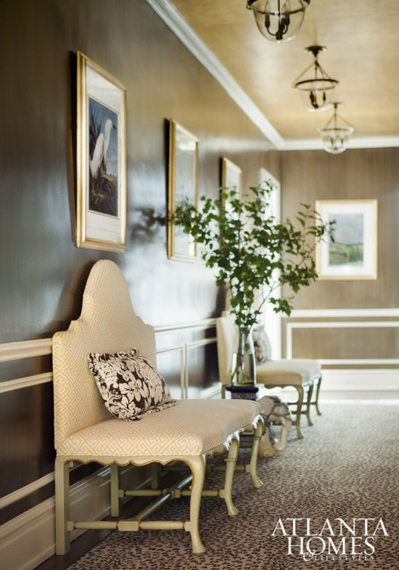 Chocolate strié paint complements gilt tea-leaf paper on the ceiling.