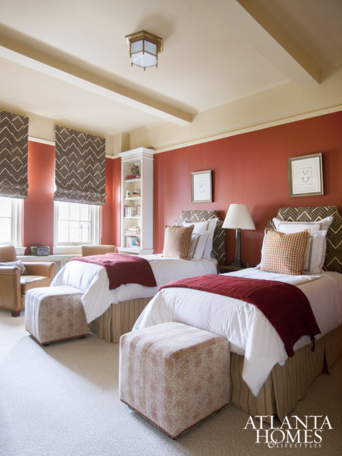 Crisp linens in a children’s bedroom balance bold reds and browns.