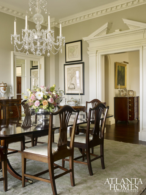 A crystal chandelier from Baccarat takes center stage in the dining room. The rug from Moattar set the tone for the soft green color palette.
