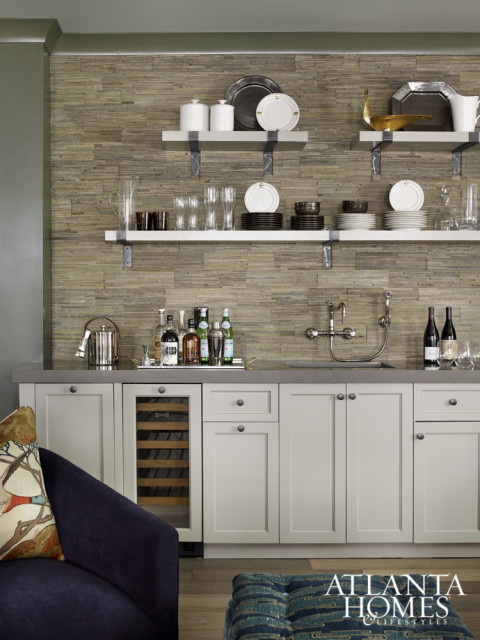 A nearby Parsons-style bar-top table provides an intimate spot to enjoy a game of cards or a drink prepared in the kitchenette.