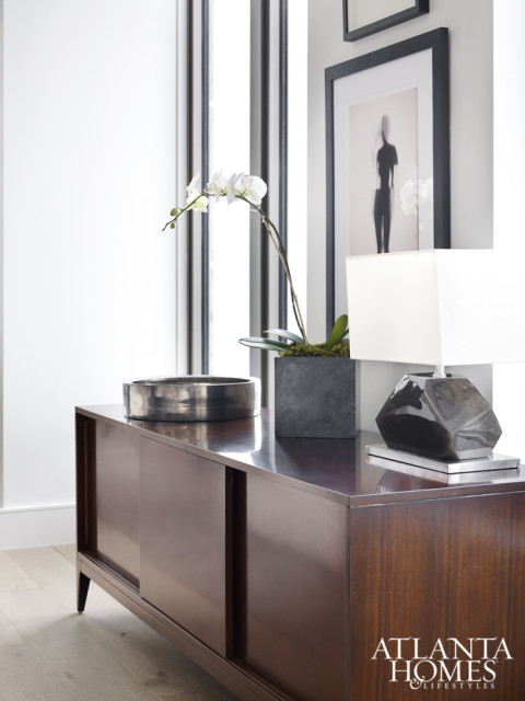 Brown chose this streamlined Baker cabinet because, “It doesn’t speak too much.” Hanging above are two black-and-white paintings, both from Townhouse by Robert Brown.