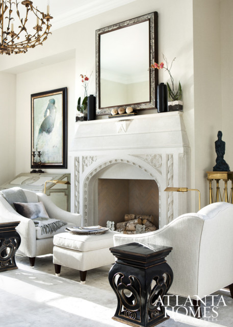 An inviting seating area next to Francois & Co.’s ornate, grey-polished Victoria stone mantle.