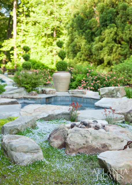 Excavated granite boulders from the yard act as sculptural pieces by the swimming pool.