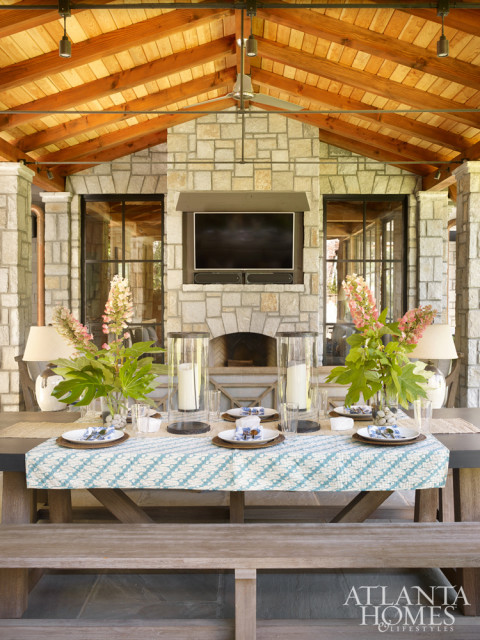 The back porch is equipped with a grill and pizza oven, perfect for a festive cookout. Its Restoration Hardware farm table and benches can accommodate casual suppers as well as more formal outdoor dinner parties.
