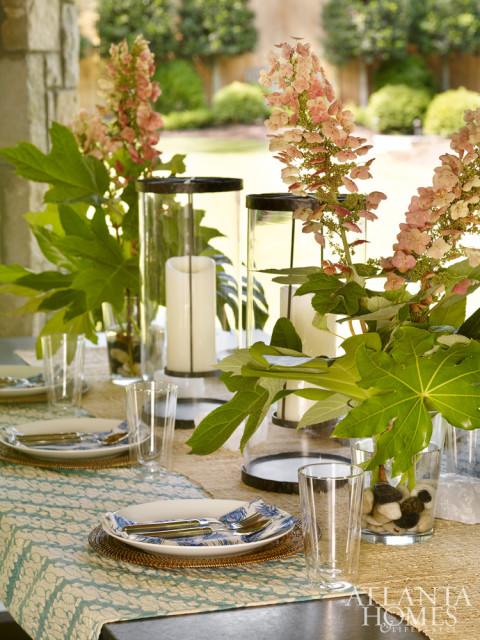 The back porch is equipped with a grill and pizza oven, perfect for a festive cookout. Its Restoration Hardware farm table and benches can accommodate casual suppers as well as more formal outdoor dinner parties.
