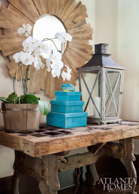 An antique table from the homeowners’ collection adds rustic appeal to the living room.