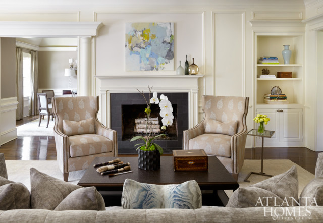 Two tailored Wesley Hall chairs—covered in Suzanne Rheinstein Paisley Linen from Lee Jofa—align the room with the fireplace.