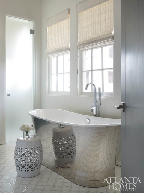 The dreamlike aesthetic continues in the master bath with inlayed marble flooring and a Waterworks soaking tub.