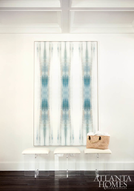 An abstract painting by Carol Benson-Cobb greets visitors in the foyer. The acrylic stools by Moss Studio are available to the trade at Codarus.