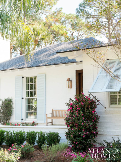 To liven up the home’s exterior, the brick was painted white and accented with charming pale blue shutters.