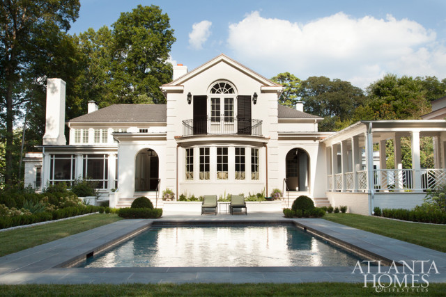 When the couple purchased the house, the porch had the feeling of one in the mountains, with a stone fireplace and dark, hand-hewn beams. Litchfield added a beadboard ceiling and box beams, and Lanham brightened the space with white paint. He also designed a breezeway that leads from the porch to the pool to balance the back elevation