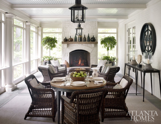 When the couple purchased the house, the porch had the feeling of one in the mountains, with a stone fireplace and dark, hand-hewn beams. Litchfield added a beadboard ceiling and box beams, and Lanham brightened the space with white paint. He also designed a breezeway that leads from the porch to the pool to balance the back elevation