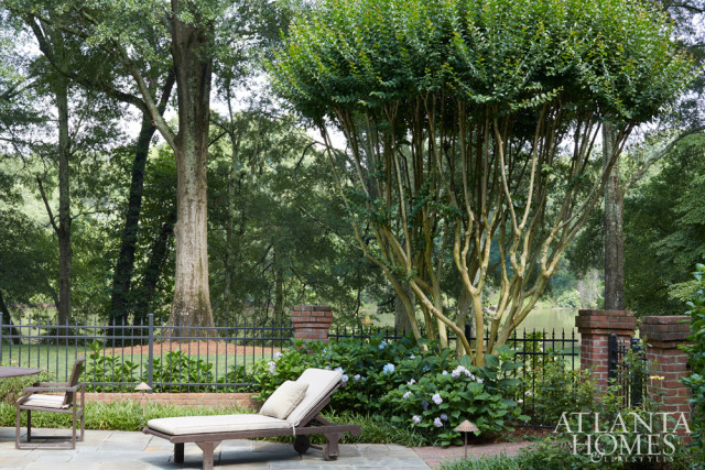 A crape myrtle towers above outdoor seating near the property’s pool.