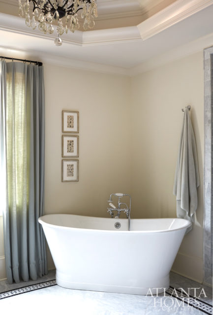 A skirted tub by Sunrise Specialty is placed in the corner of the master bath so as not to take up additional real estate in the room.