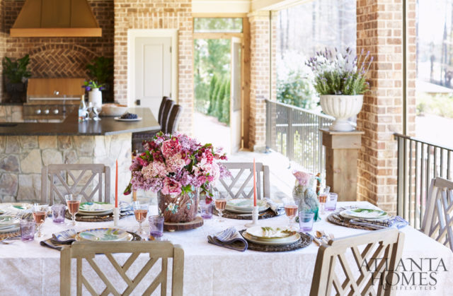 Overlooking the varied hues of a lush golf course, the rear patio is ready for entertaining thanks to weather-resistant furnishings from Restoration Hardware and retractable screens.