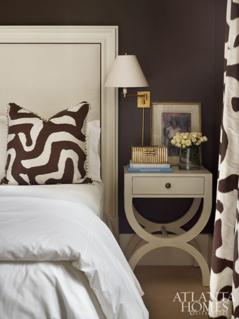 A bold Jed Johnson fabric from Travis & Company in the guest bedroom echoes the rich brown walls. The heaboard is Century; the nighstand is Tritter Feefer.