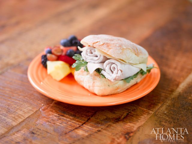 Roasted turkey and arugula with a side of fresh fruit.