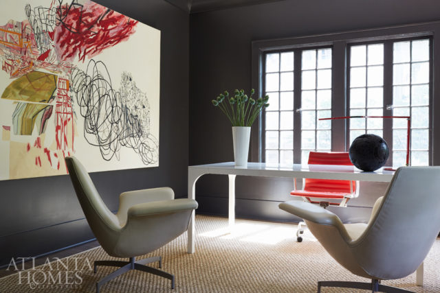 “We wanted to add some drama in the study, so we painted everything in our favorite black color,” says Pritchett. They were able to salvage the home’s original 1920s wood floors in this room. The painting is by Rocio Rodriguez, also a Virginia-Highland resident. Lounge chairs from HBF Furniture’s Dialogue collection were upholstered in buttery soft leather from Edelman. The desk is from CB2 and the desk chair is vintage Herman Miller.