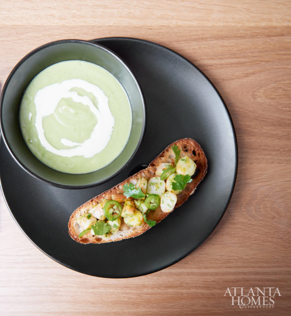 Chilled avocado soup, topped with crème fraiche and served with shrimp toast.