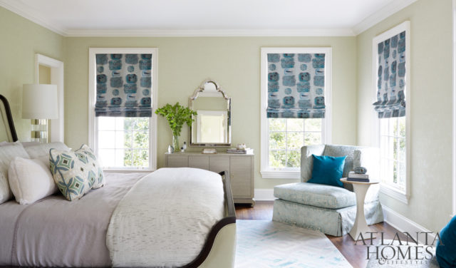 A Weitzner Cheval wallcovering is soothing in the master bedroom, outfitted with Urban Decors window treatments in Opuzen Strata fabric and the Lee Industries Slipcover Chair in Pollack’s Hmong Plush fabric.
