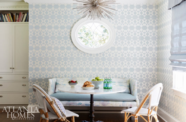 Phillip Jeffries’ pale blue Zephyr wallcovering cultivates a fresh feel in the breakfast nook, where a sofa from Lee Industries—covered in Beacon Hill’s Soo Locks and Kravet’s Valera Spa fabrics—snuggles up to a marble-topped bistro table and chairs.