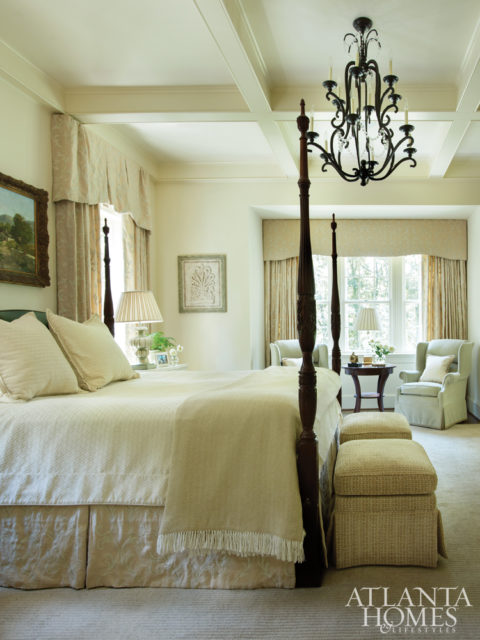 In the master bedroom and bath, custom draperies in a luxe Cowtan & Tout fabric frame garden views.