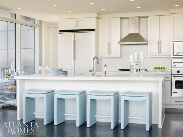 Custom powder-blue leather stools in the kitchen add punch to the space.