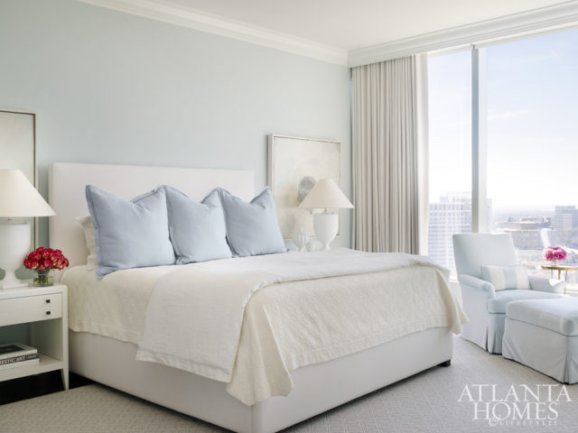 The master bedroom’s light-blue walls not only pull in the color scheme from the nearby living room but also add dimension to the space. Bedside vignettes include nightstands from Hickory Chair and art by Barbara Brenner through Bill Lowe Gallery.