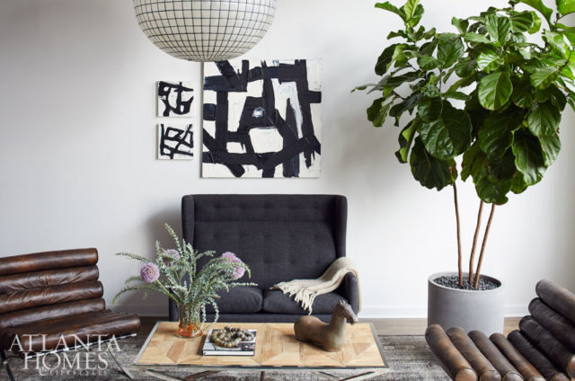 The living room’s clean-lined furnishings showcase Hardy’s love for darker colors.