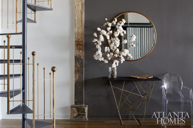 A mix of metals help soften the industrial vibe in designer Minhnuyet Hardy’s Atlanta loft. She refreshed the original staircase by painting the railing a glimmering gold.