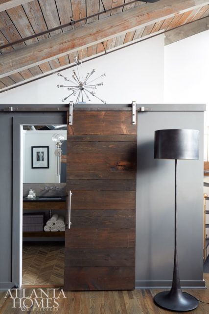 An oversize black metal floor lamp by Regina Andrew sits pretty next to the newly minted master bath door.