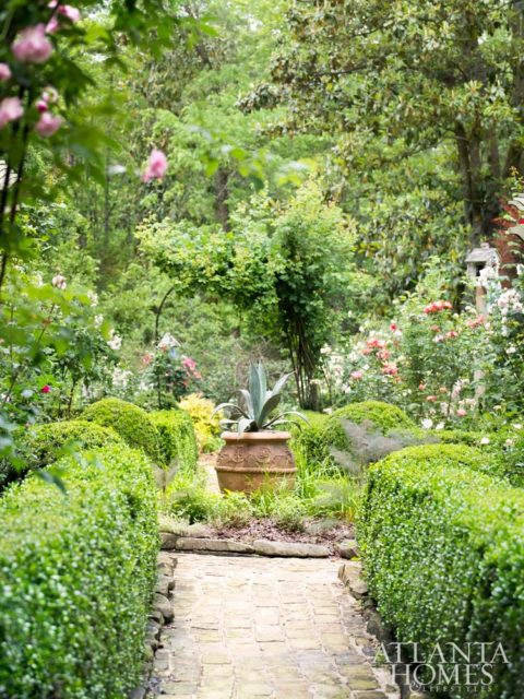 The Tim Stoddard-designed rose garden is framed by clipped boxwood hedges.