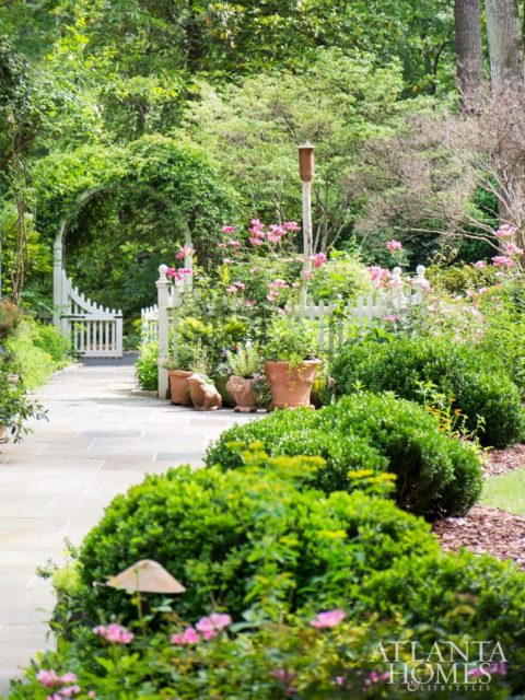 Playful groupings of ball boxwood frame the courtyard garden’s bluestone path. An array of annuals accent Italian terra cotta pots while Betty Prior roses climb skyward.