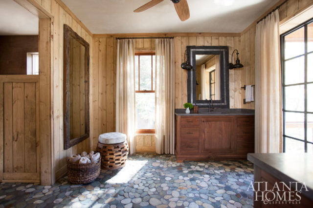 For the master bathroom, individually placed split rocks form the floor.