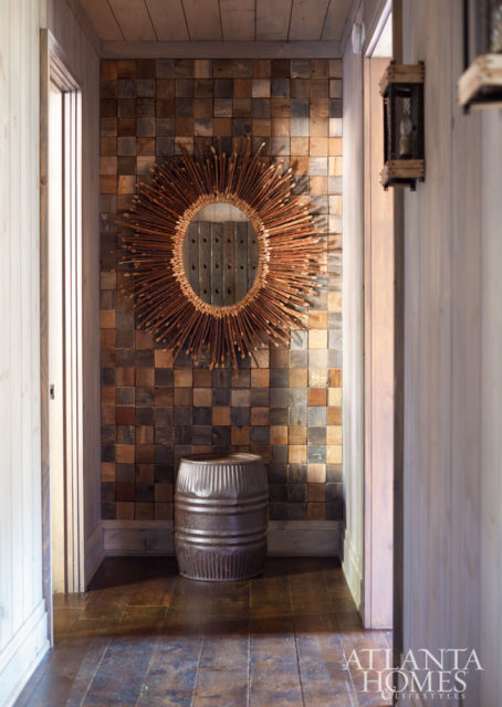 At first glance, the wall at the master bedroom entrance looks like tiles, but it is actually the ends of varying wood pieces of barn wood.