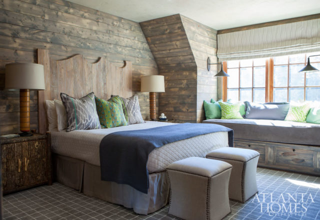 For a guest bedroom, King chose a muted gray wash for the wood walls, giving the room a seamless look along with the other soft shades of blue and green.