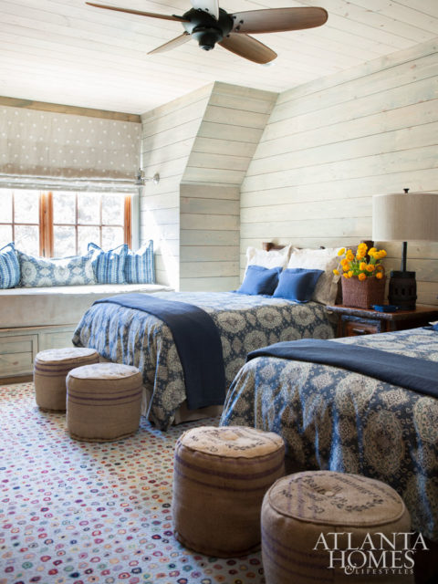 A guest room shows off pattern play between the bed spreads and the indoor-outdoor rug.