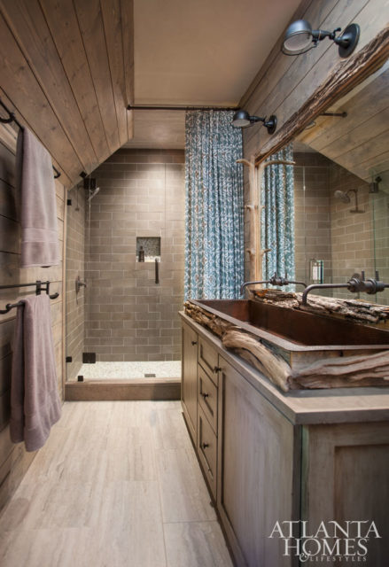 River wood wraps around the sides of this copper sink for a unique touch.